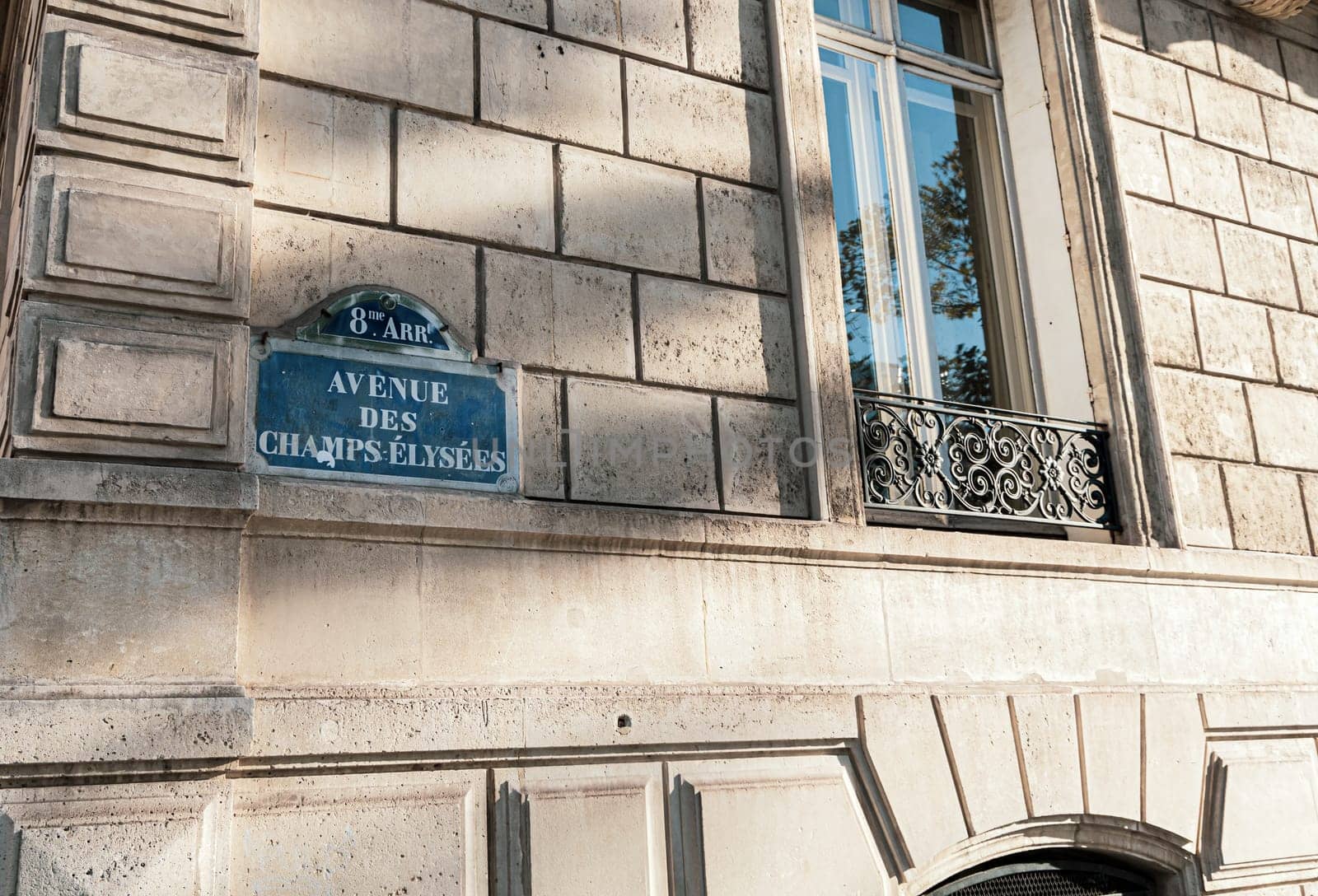 Central street name sign The Avenue des Champs-Elysees. Paris, France - January 18, 2025