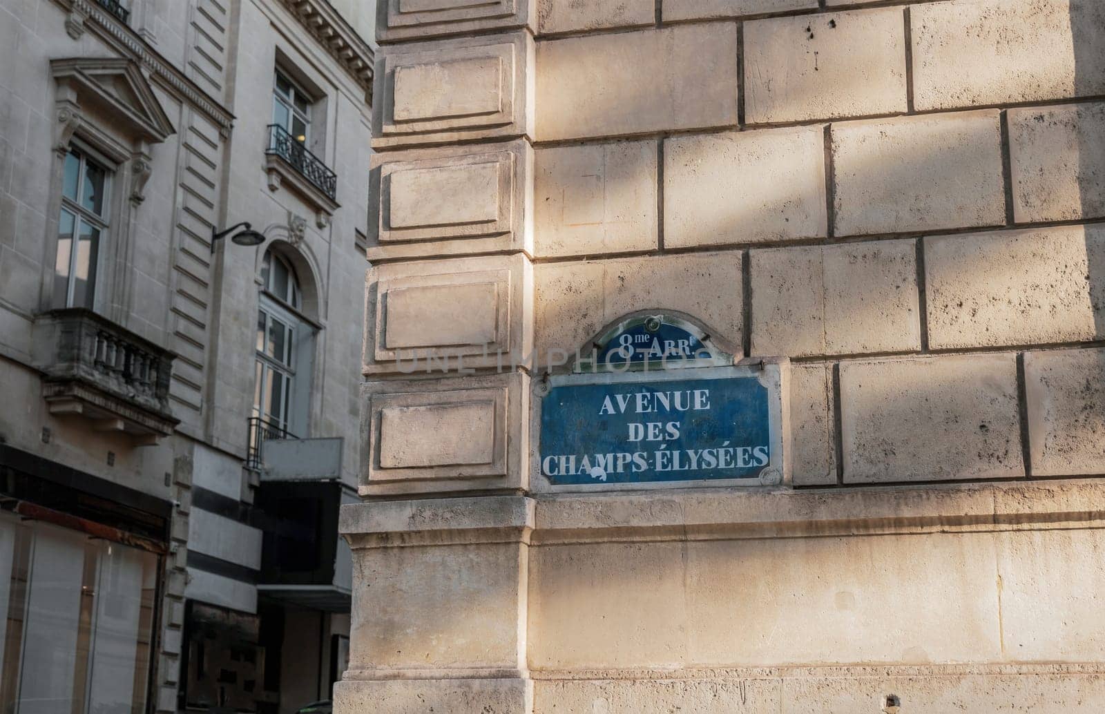 Central street name sign The Avenue des Champs-Elysees. Paris, France - January 18, 2025