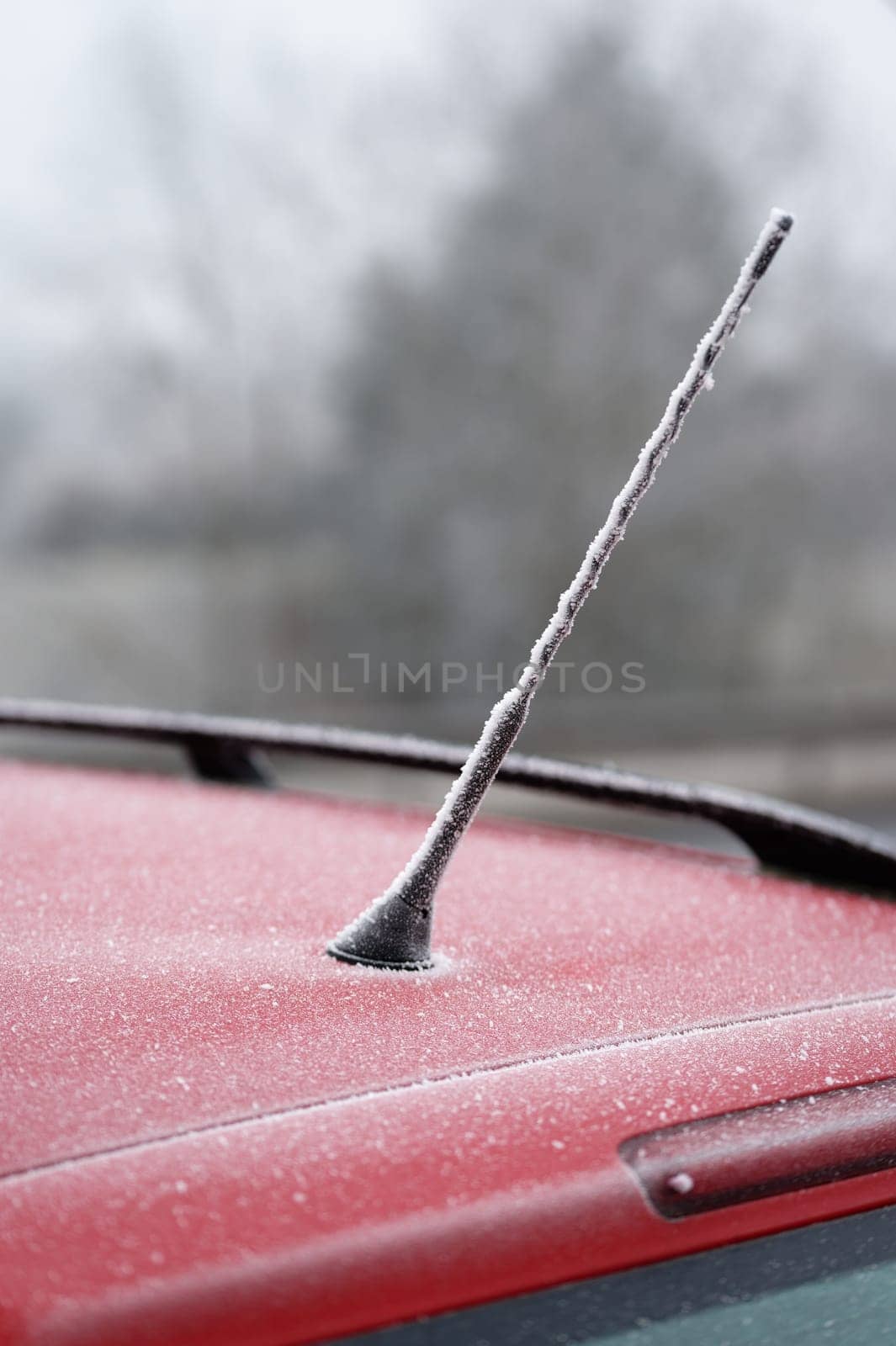 Frozen roof with antenna on car. Concept for winter time and transportation