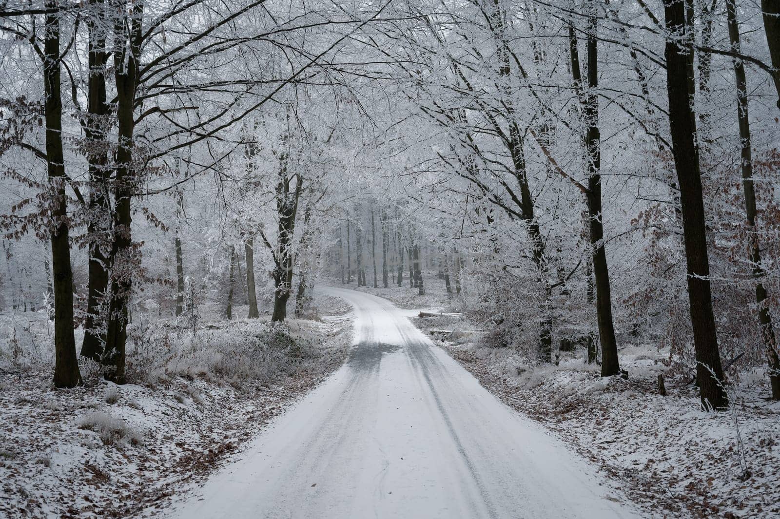 Snowy winter road with car. Dangerous car driving in the mountains in the winter. Concept for transportation, cars and travel.