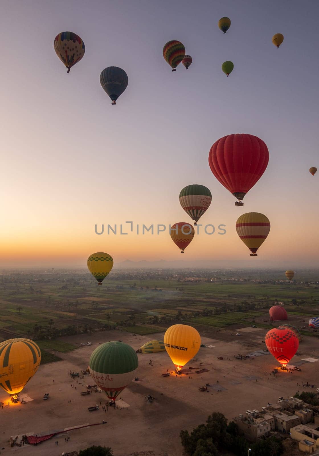 Luxor, Egypt - 31 October 2024: Many hot-air balloons over Sahara desert and Valley of Kings near Luxor, Egpyt