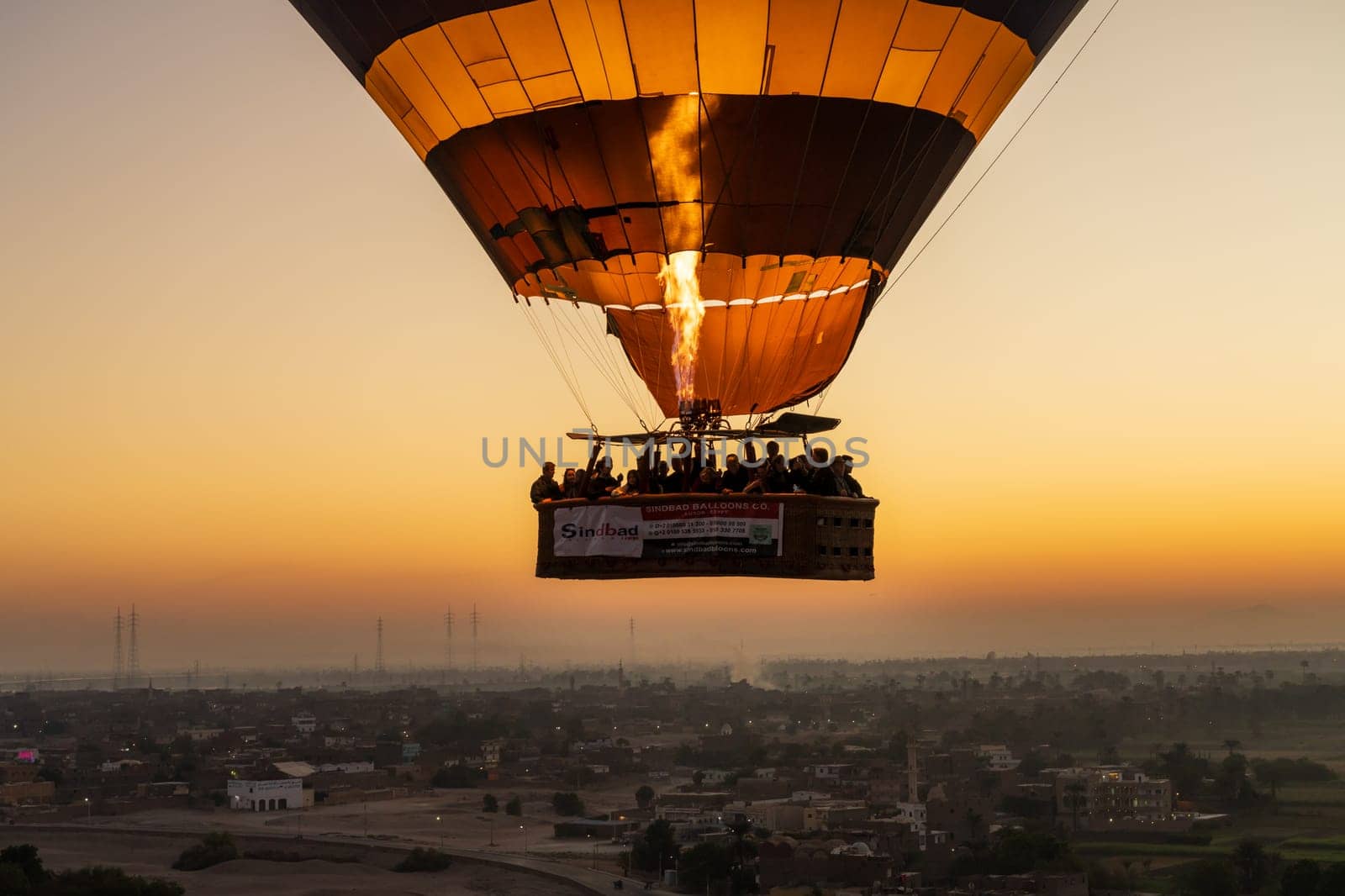 Luxor, Egypt - 31 October 2024: Hot-air balloon over Sahara desert and Valley of Kings near Luxor, Egpyt