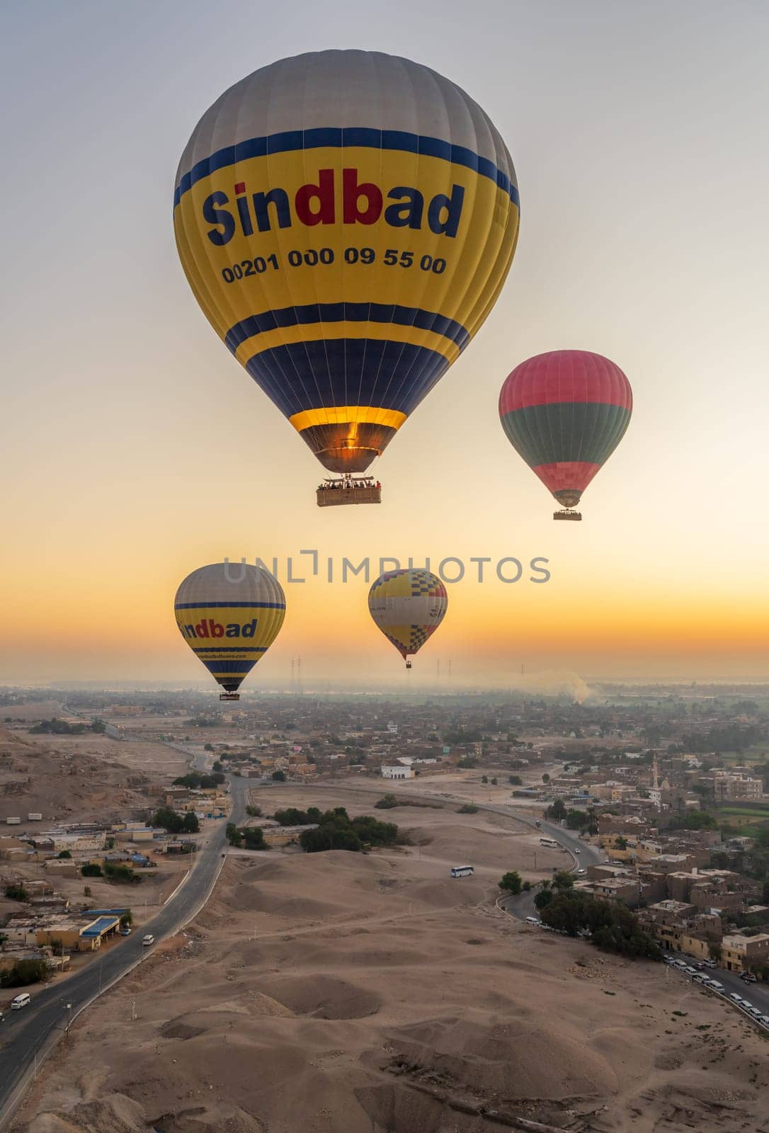 Luxor, Egypt - 31 October 2024: Many hot-air balloons over Sahara desert and Valley of Kings near Luxor, Egpyt