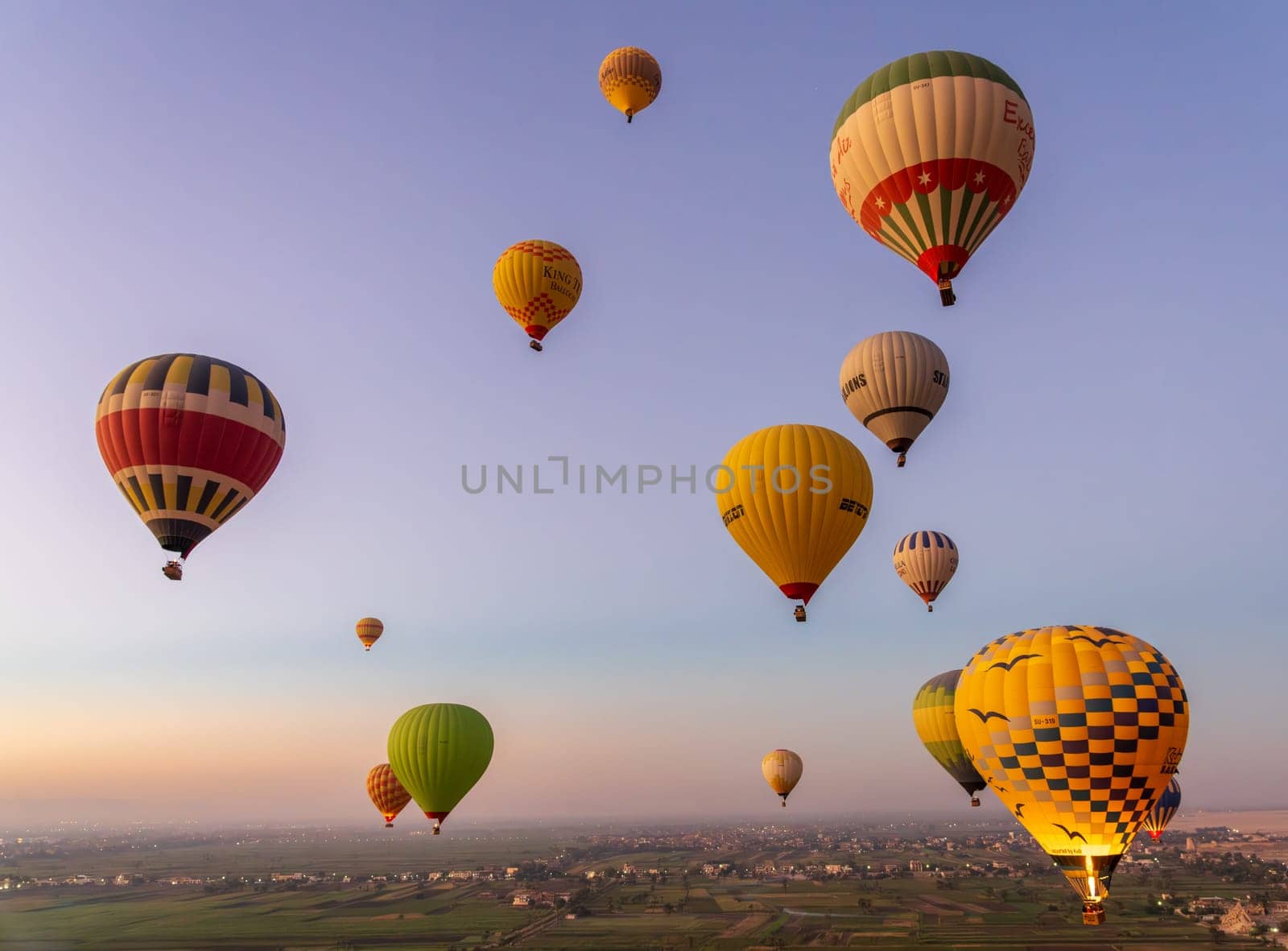 Luxor, Egypt - 31 October 2024: Many hot-air balloons over Sahara desert and Valley of Kings near Luxor, Egpyt