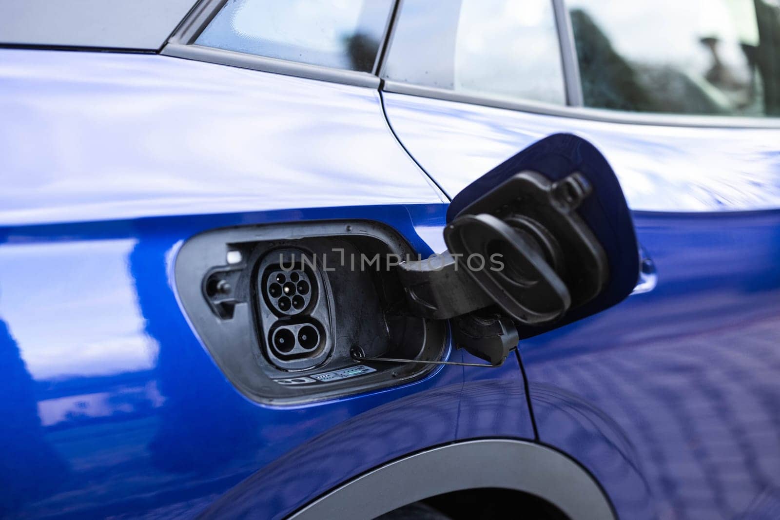 Fast charging socket type 2 combo electric car. Type 2 CCS plug port on electric vehicle. DC - CCS type 2 EV charging connector at EV car. Eco friendly alternative energy green environment concept