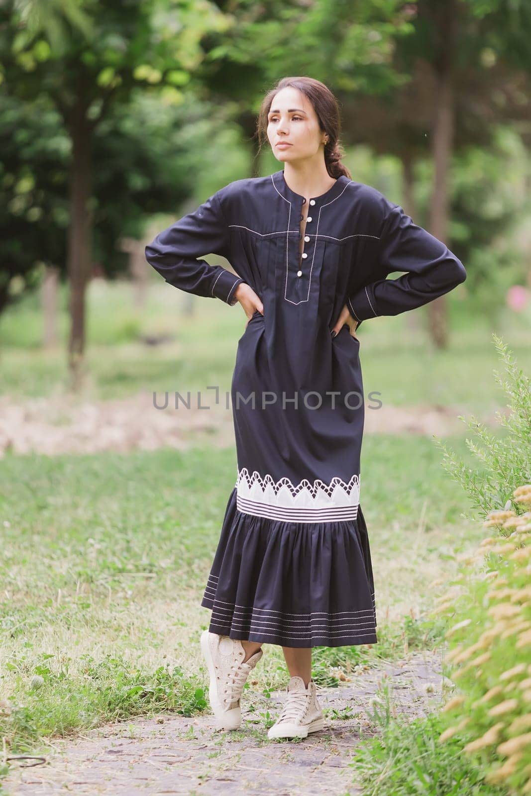 Beautiful woman in vintage white dress standing outdoor, film grain, selective focus. by sarymsakov