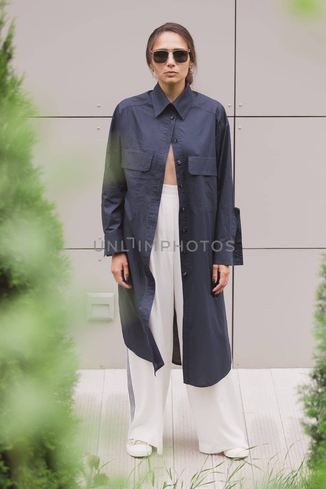 Woman tenderly standing in kimono on gray background. The girl seductively wear her robe by sarymsakov