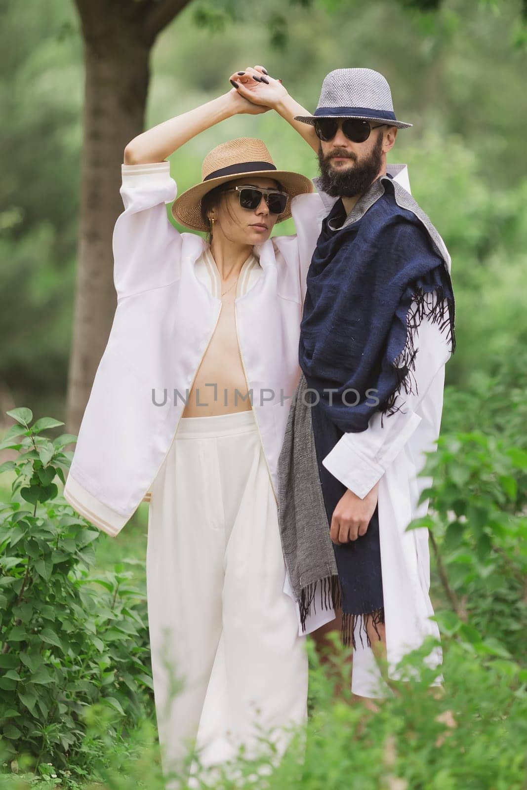 full length view of fashionable couple looking at camera outdoor.