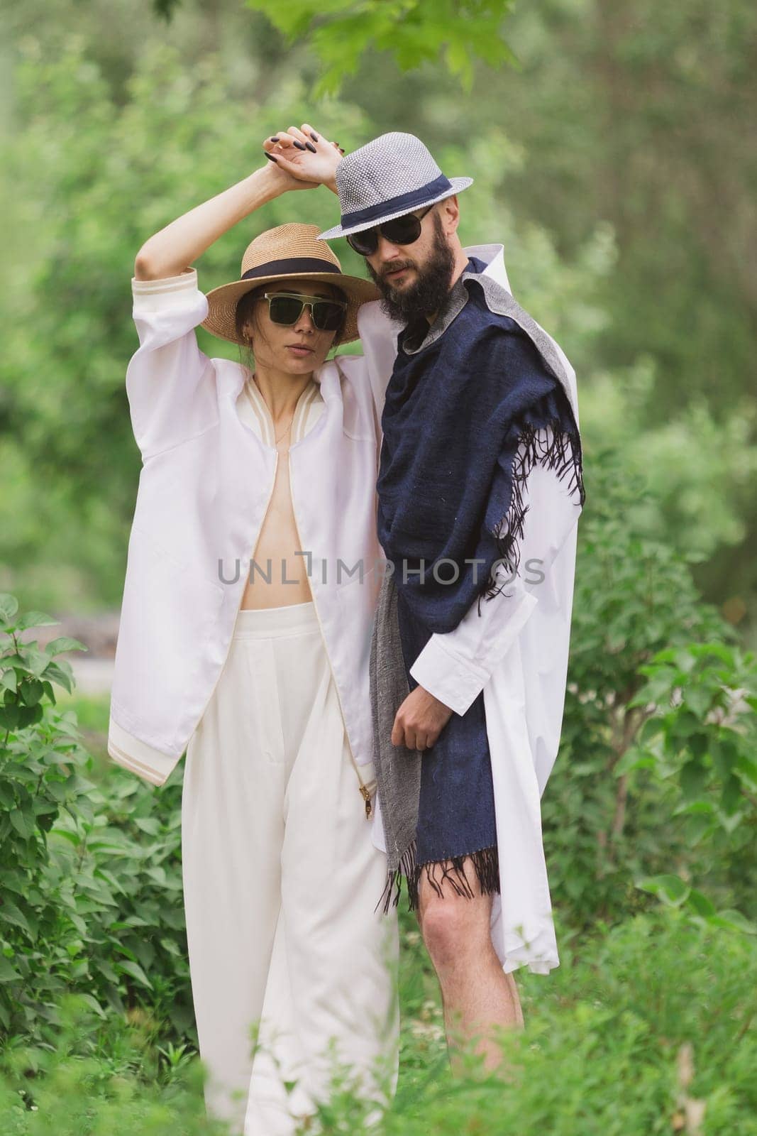 full length view of fashionable couple looking at camera outdoor.