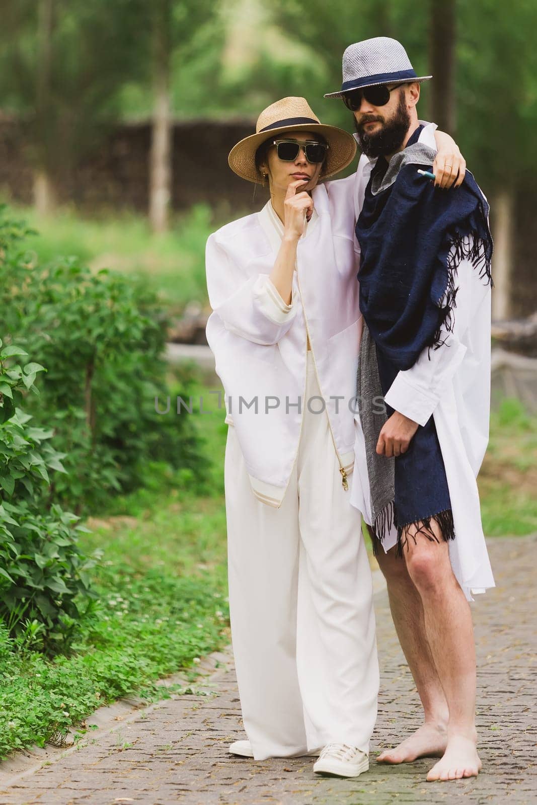 full length view of fashionable couple looking at camera outdoor by sarymsakov