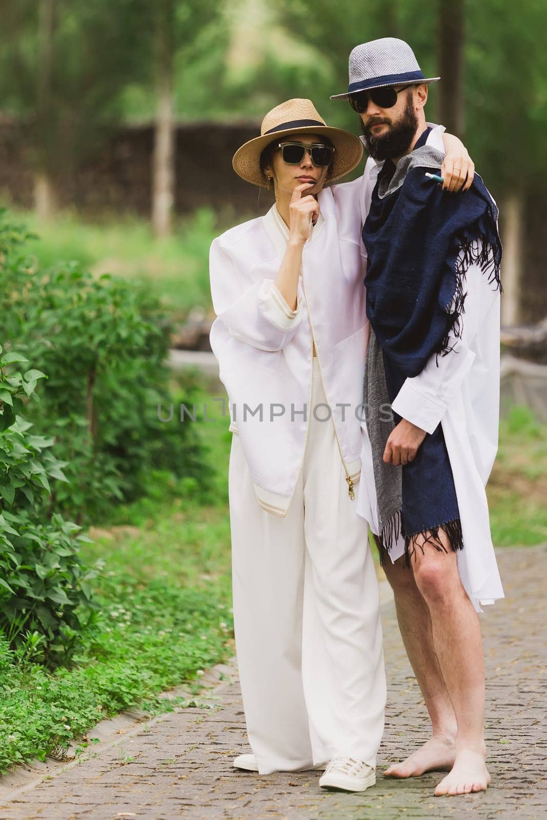 full length view of fashionable couple looking at camera outdoor.