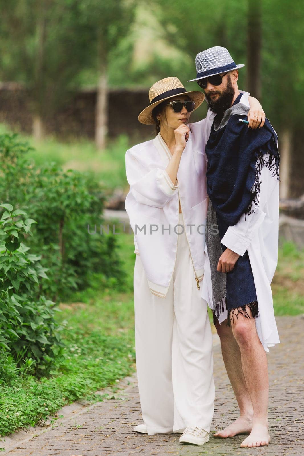 full length view of fashionable couple looking at camera outdoor.