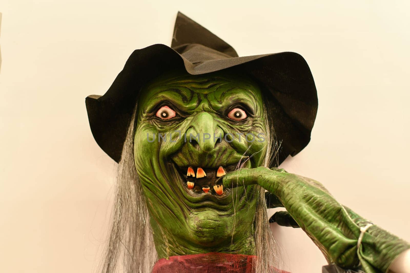 Head of a green monster with bulging eyes