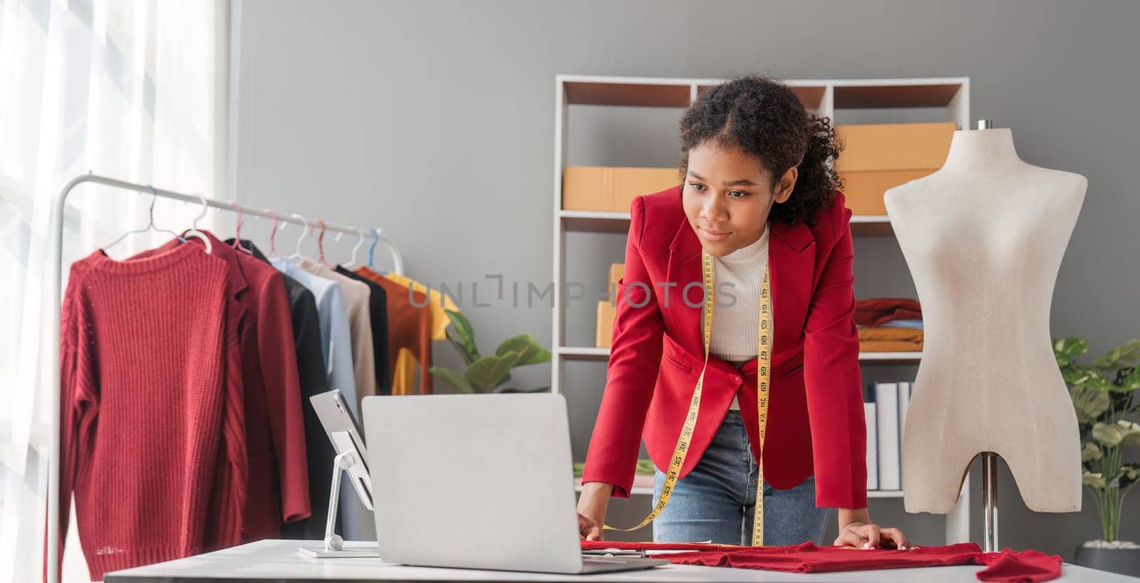 Portrait of young beautiful woman fashion designer stylish stand and working with color samples.Attractive young asian girl working with colorful fabrics at fashion studio.