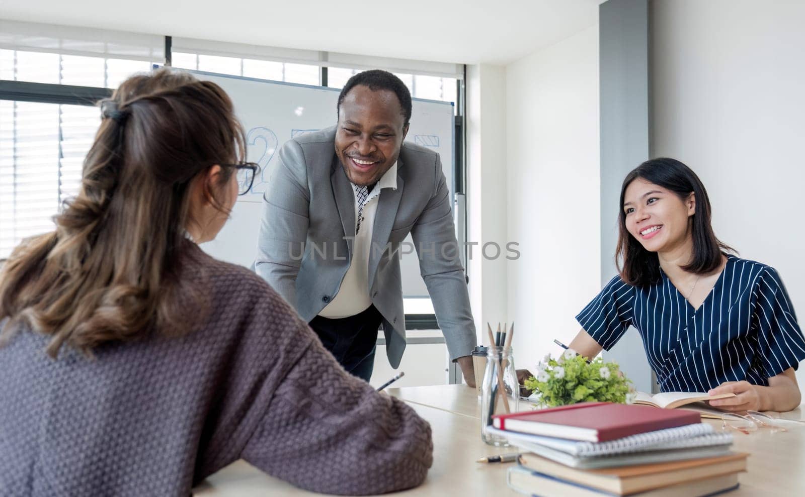 Business People Meeting using laptop computer,calculator,notebook,stock market chart paper for analysis Plans to improve quality next month. Conference Discussion Corporate Concept...