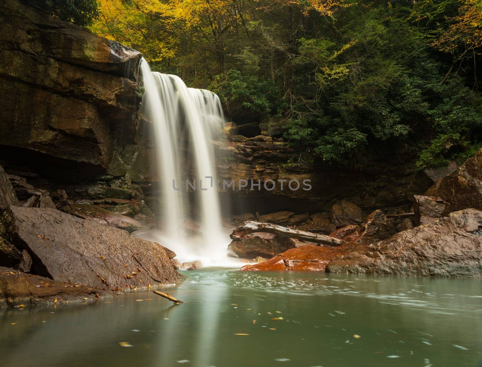 Twin cascades of Douglas Falls and calm lagoon stained with the remains of West Virginia coal mining near Thomas WV