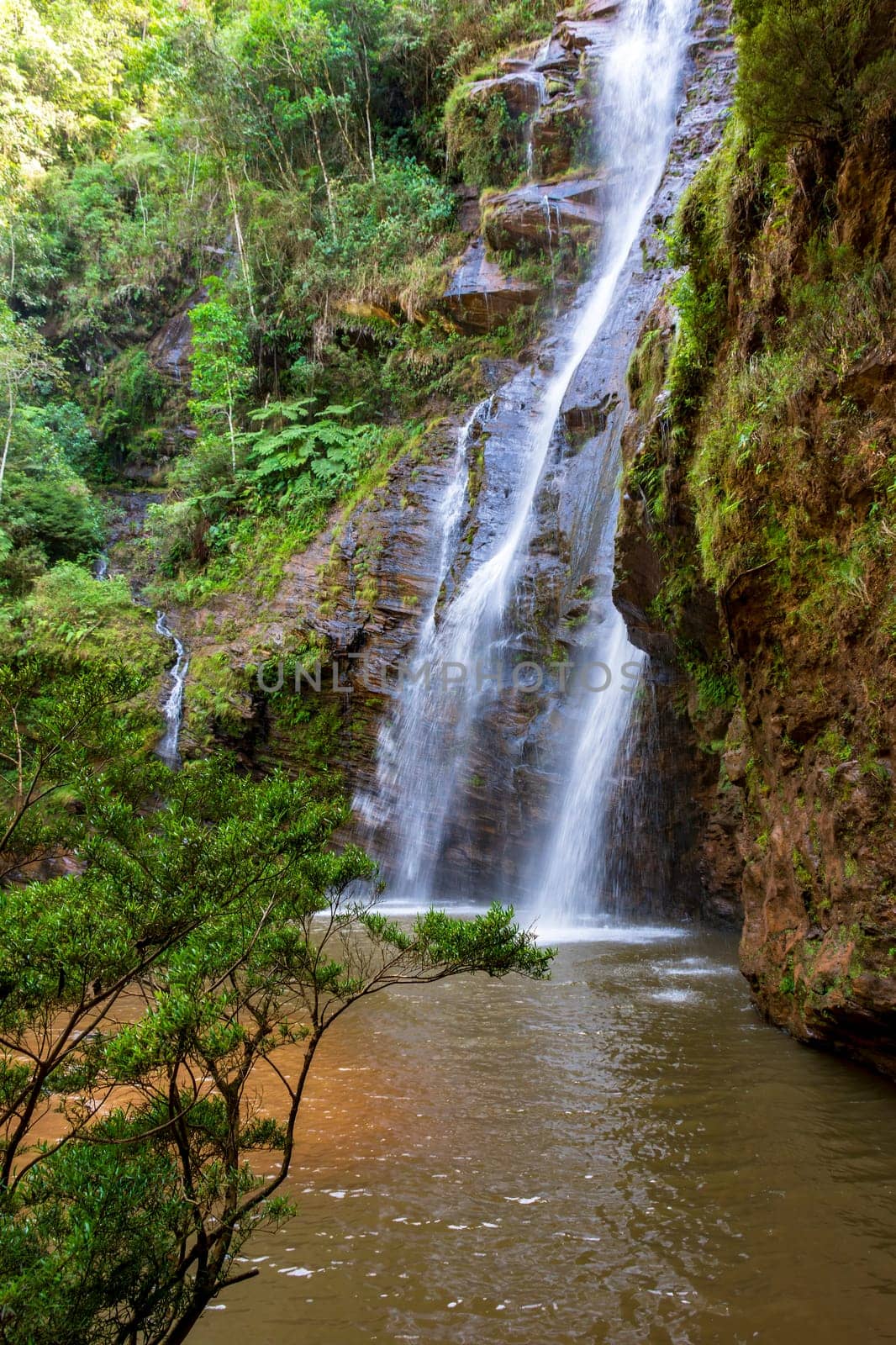 Beautiful waterfall among the dense vegetation by Fred_Pinheiro