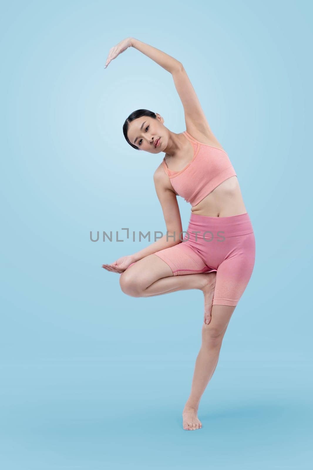 Asian woman in sportswear doing yoga exercise posing. Vigorous by biancoblue
