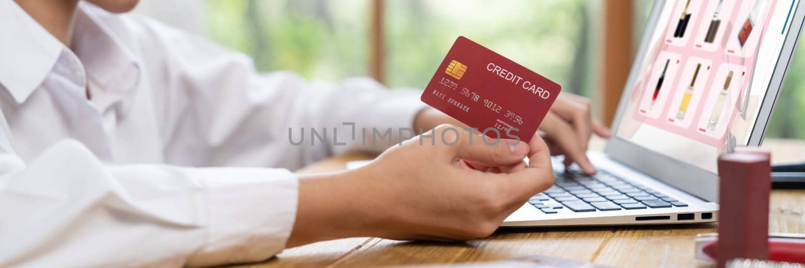 Woman shopping online on internet marketplace browsing for sale items for modern lifestyle and use credit card for online payment from wallet protected by uttermost cyber security software