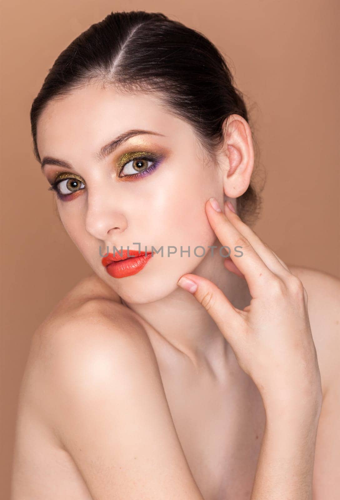 Beauty fashion girl. Portrait of beautiful young woman with fresh clean skin on baige background