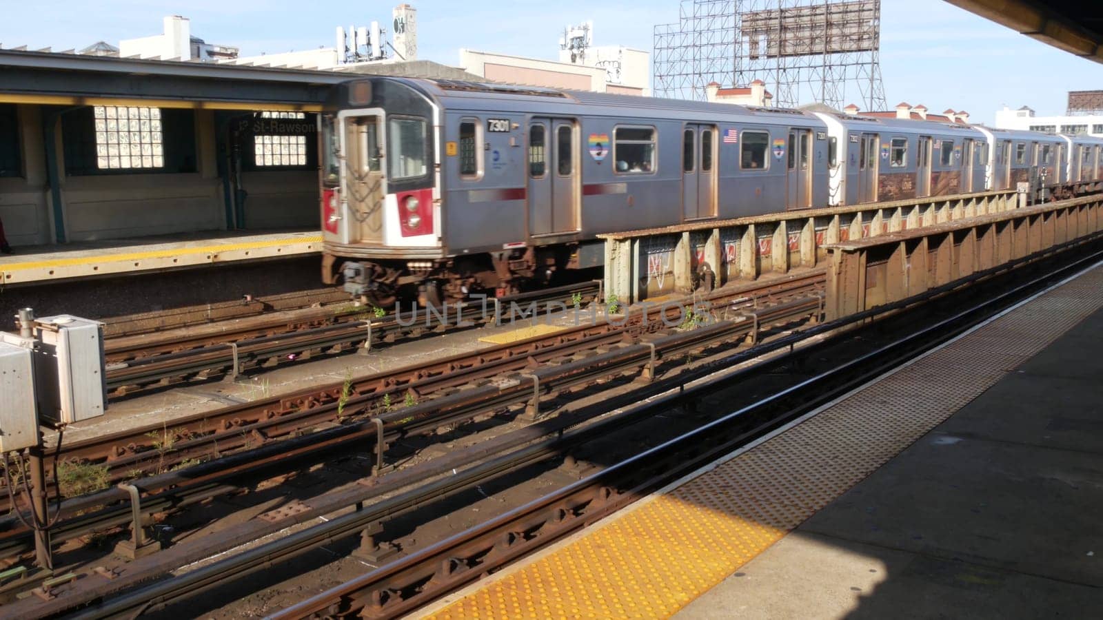 New York City, United States - 2 Sept 2023: Subway station. Metro train on public transportation platform. Elevated outdoor railway, 7 line in Queens. NYC passenger railroad traffic, Long Island City.