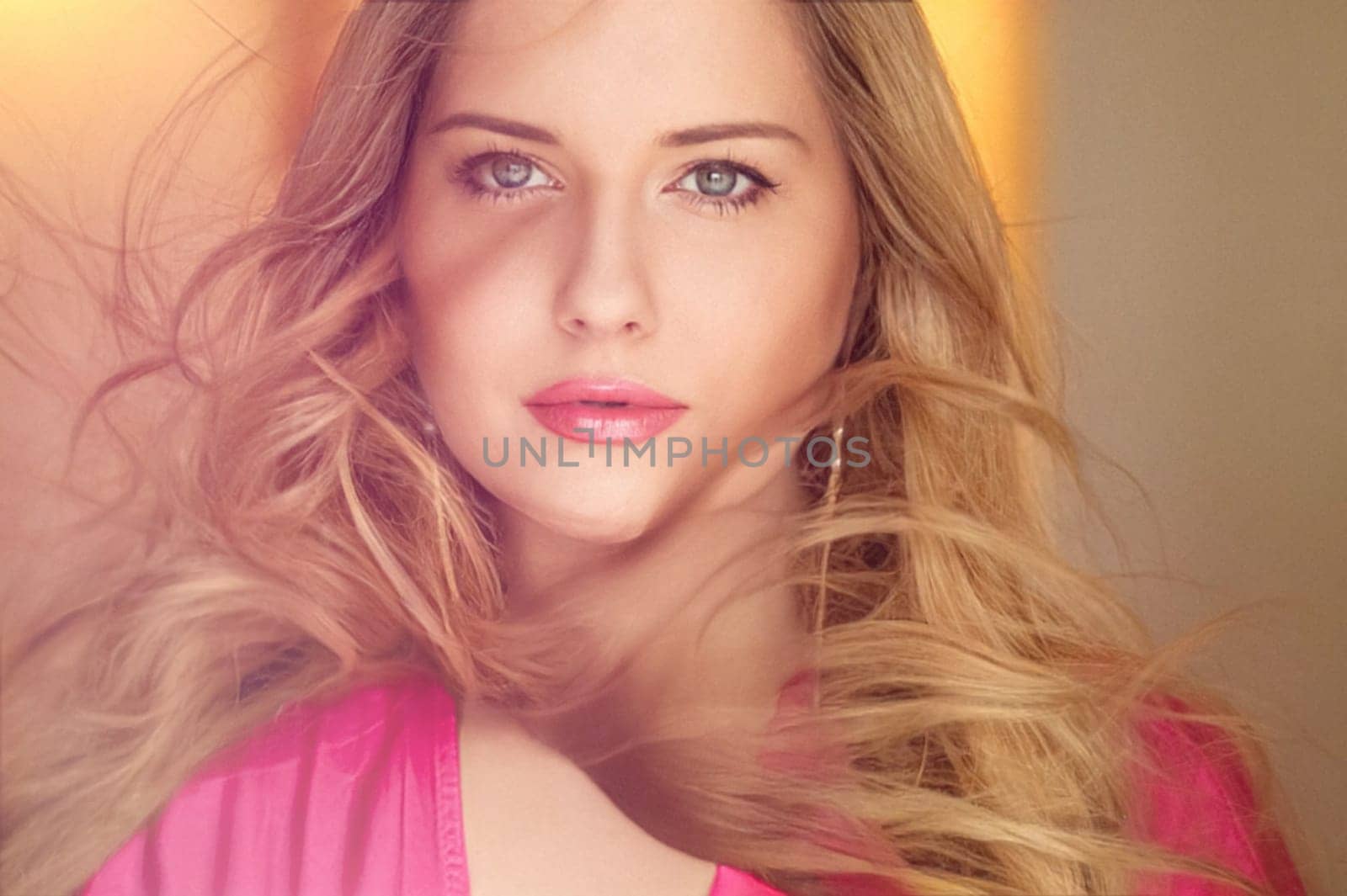 Woman with blue eyes and long, voluminous blonde hair styled in soft curls, wearing pink dress and elegant earrings, dreamy and feminine look idea