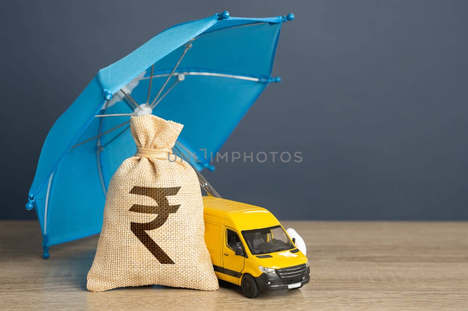 Delivery van and money bag with indian rupees under a blue insurance umbrella. Cargo and parcel insurance. Warranty obligations. Protection in conditions of military aggression. Logistics security.