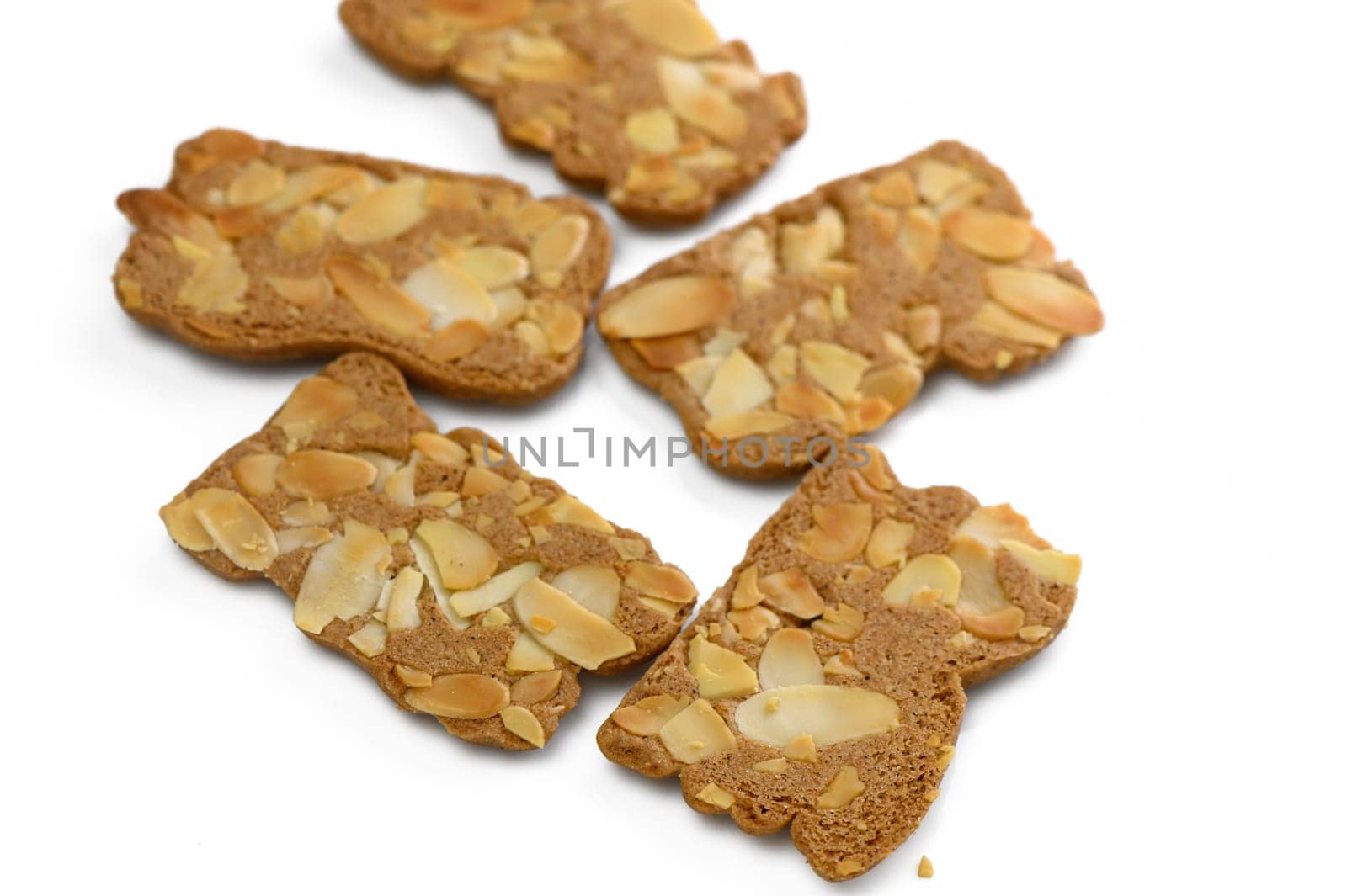 Sweet almond delights scattered creatively on a white background promise a delightful taste experience.