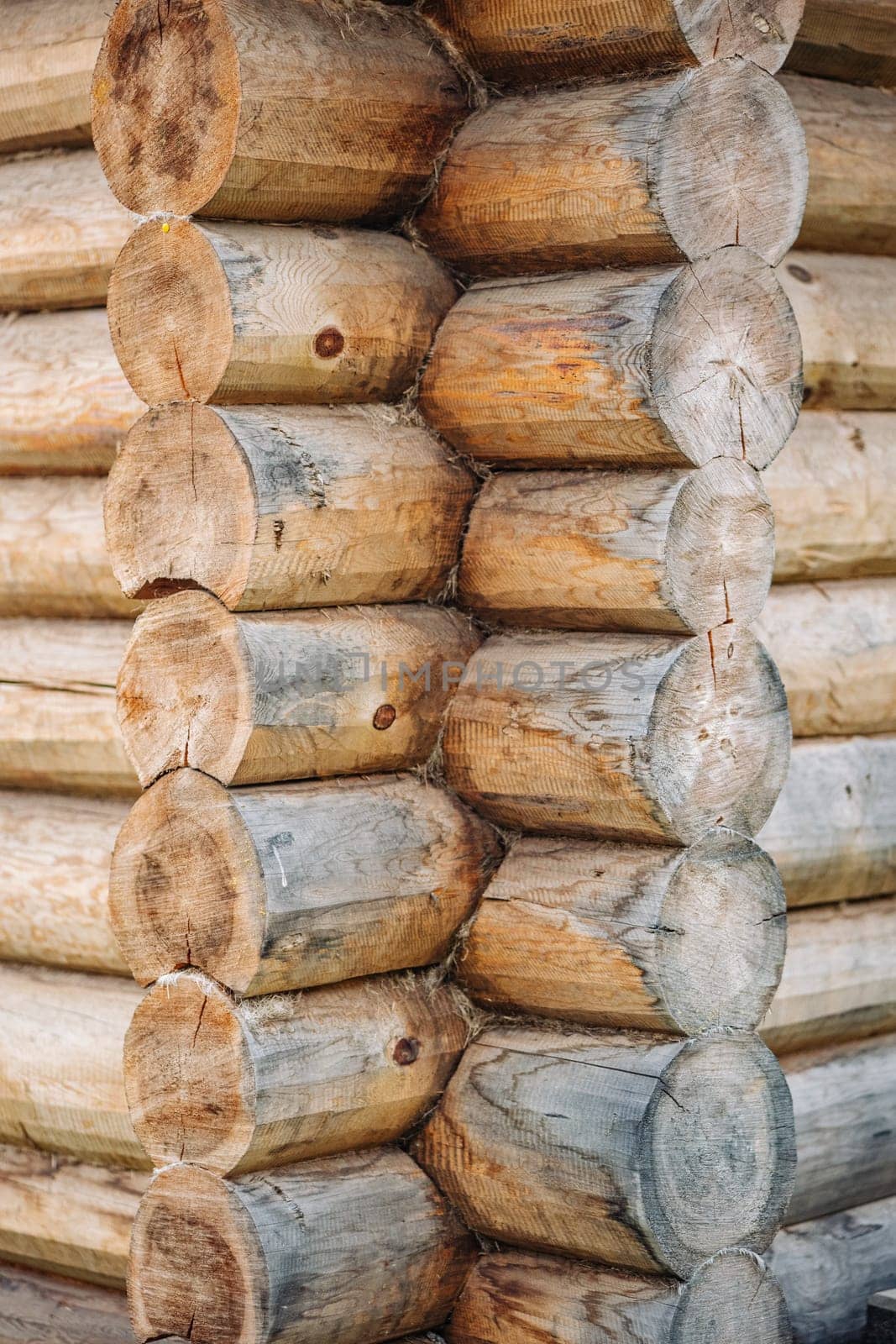 Close up view of a corner of a log cabin showcasing the traditional building technique with interlocking logs, highlighting craftsmanship and natural materials