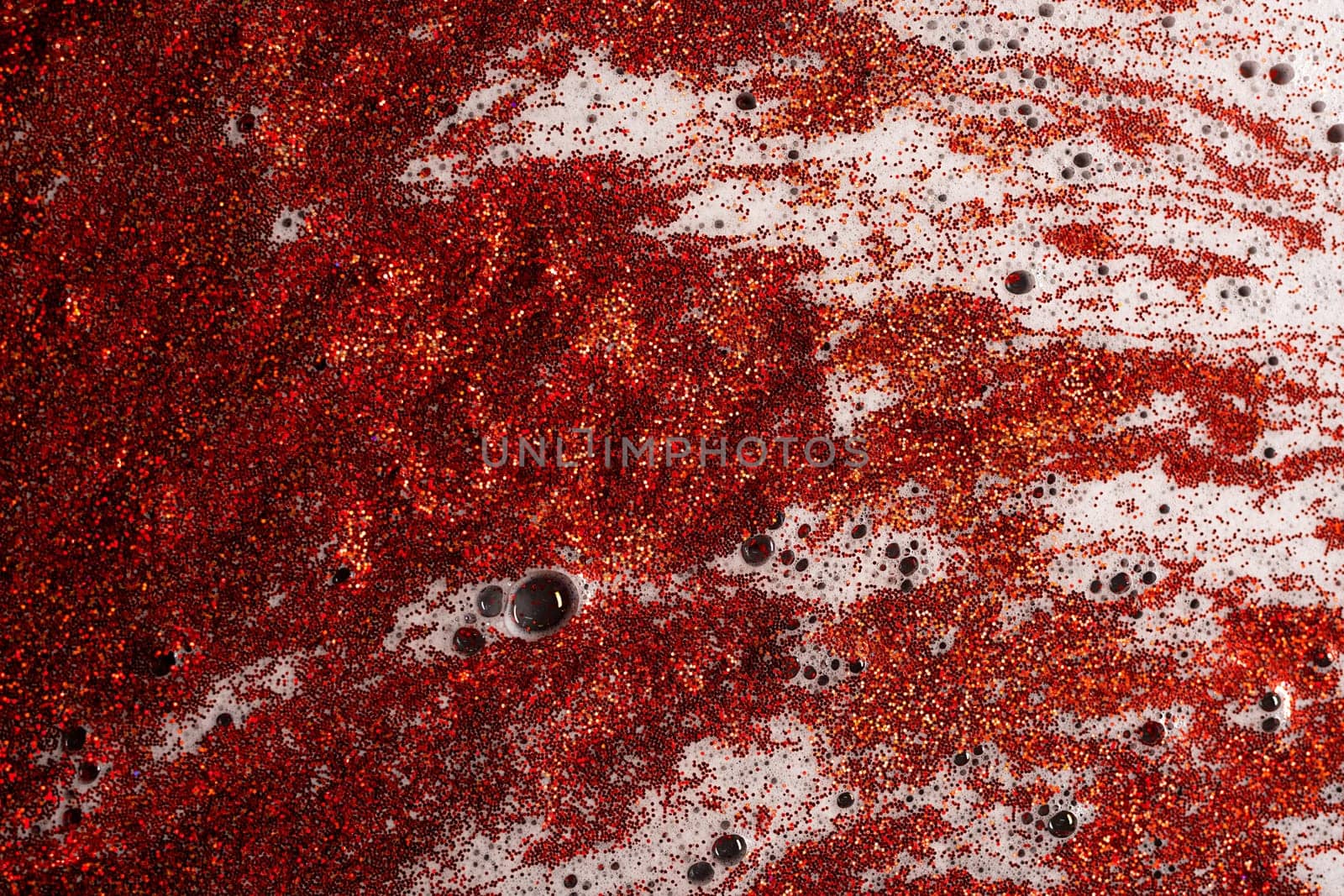 Bright red sparkles mixed with white colour shine with shimmering reflected light