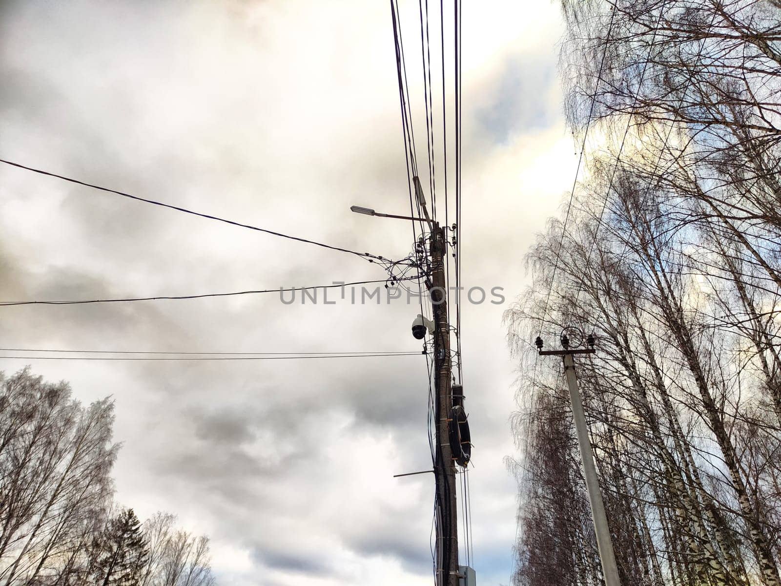 Old pole with wires against the sky. Electric transmission line, Eco-friendly energy