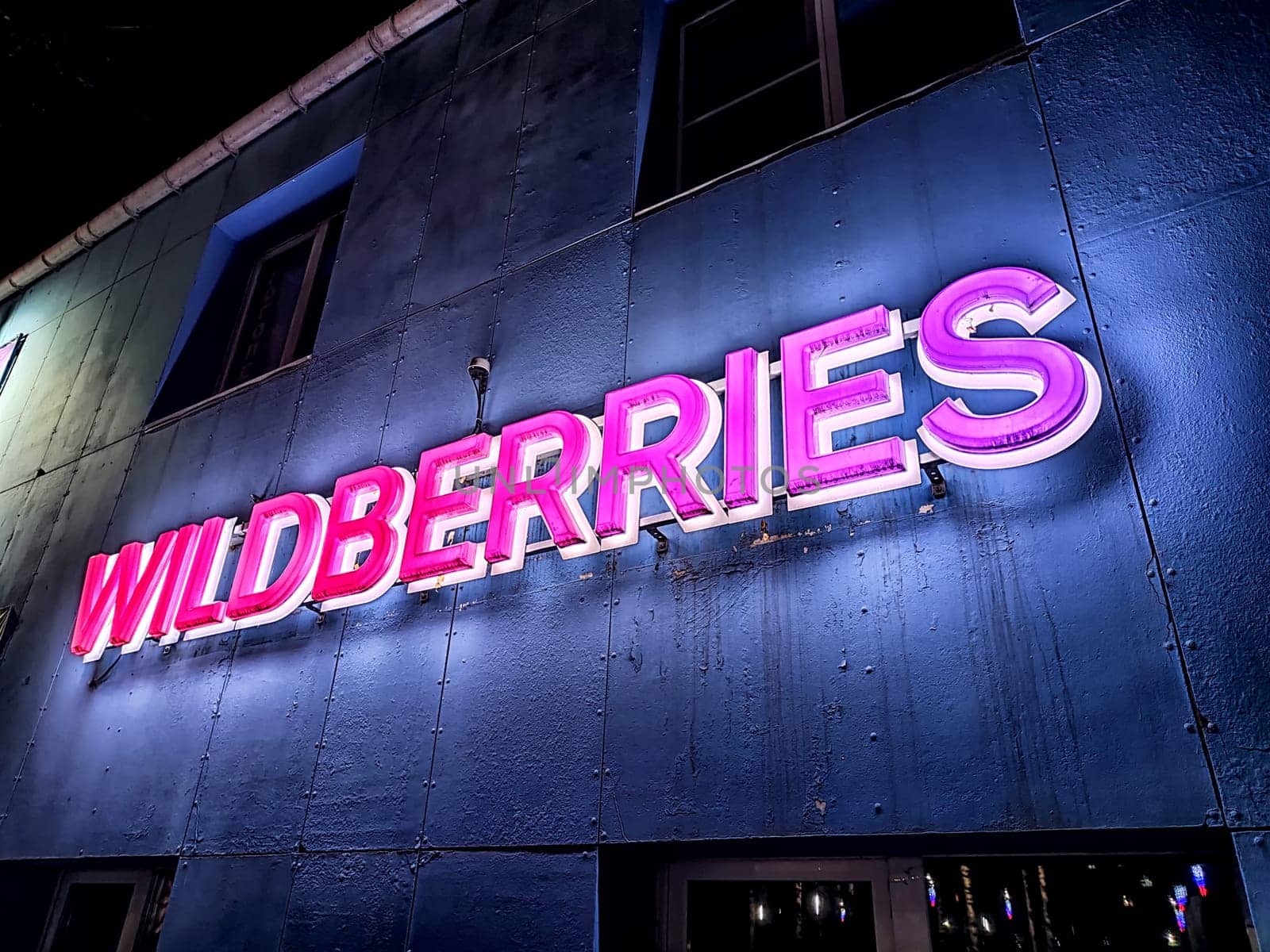 Kirov, Russia - November 19, 2024: Vibrant neon logo shines on a building exterior, representing a modern online marketplace focused on diverse products.