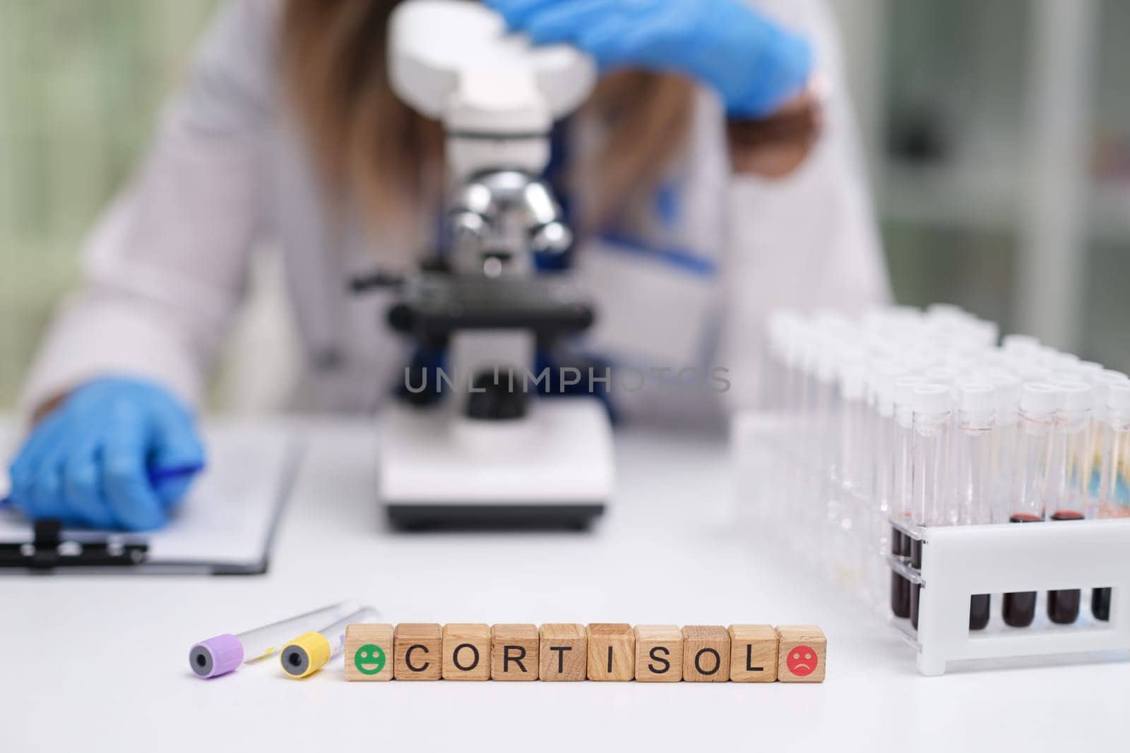 In a laboratory setting, scientists carefully analyze cortisol levels using advanced microscopes and test tubes