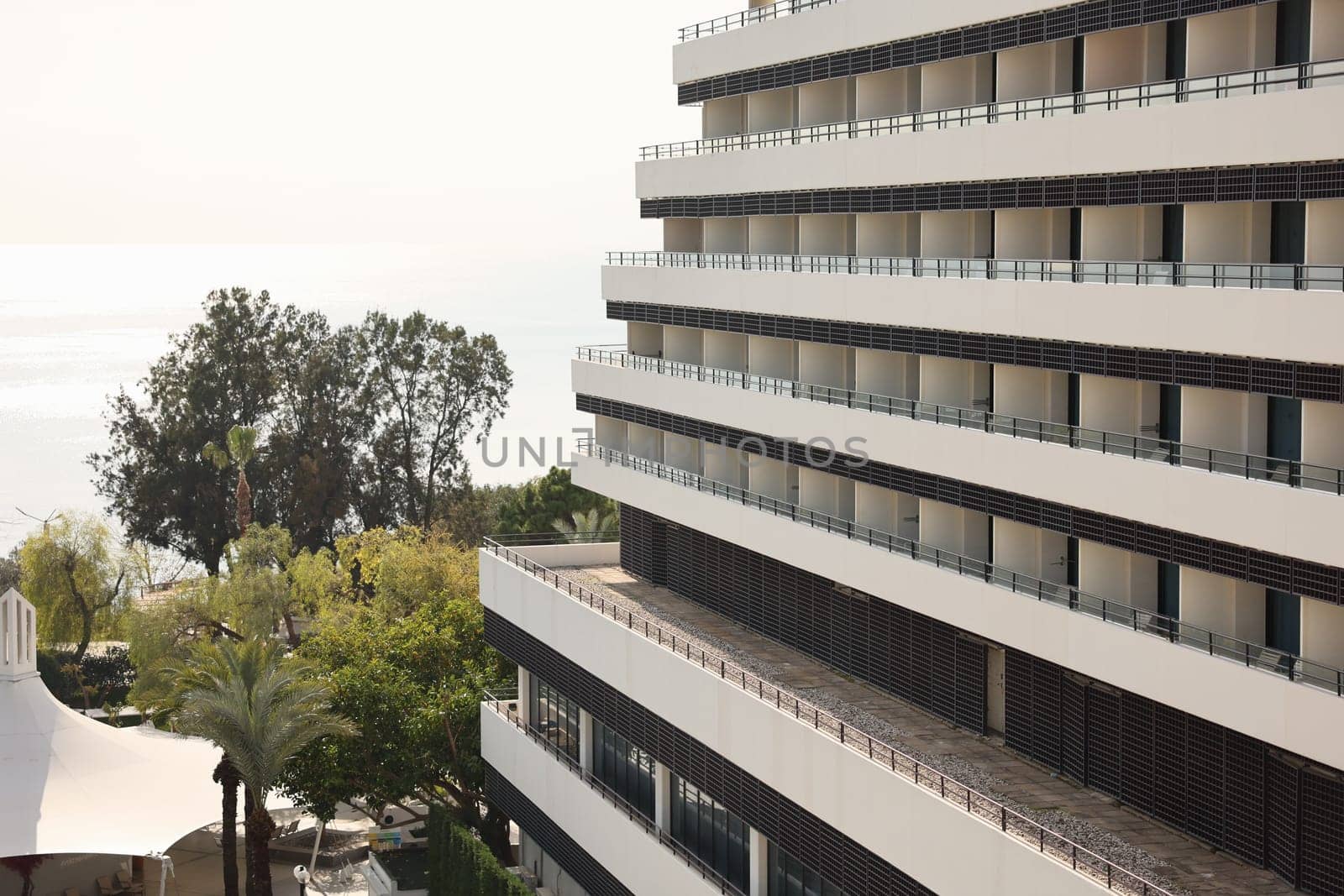 This modern hotel has lovely balconies, lush greenery, and stunning ocean views, ideal for relaxation