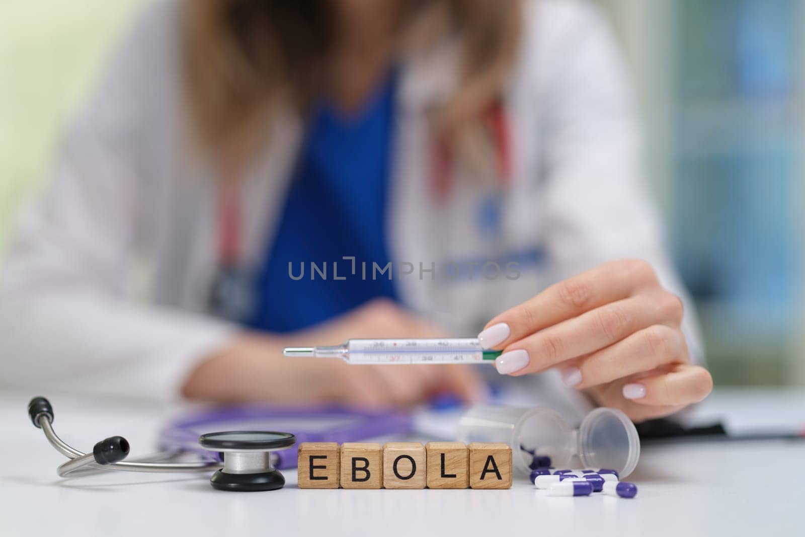 A healthcare professional emphasizes Ebola awareness using essential medical tools for safe education and care