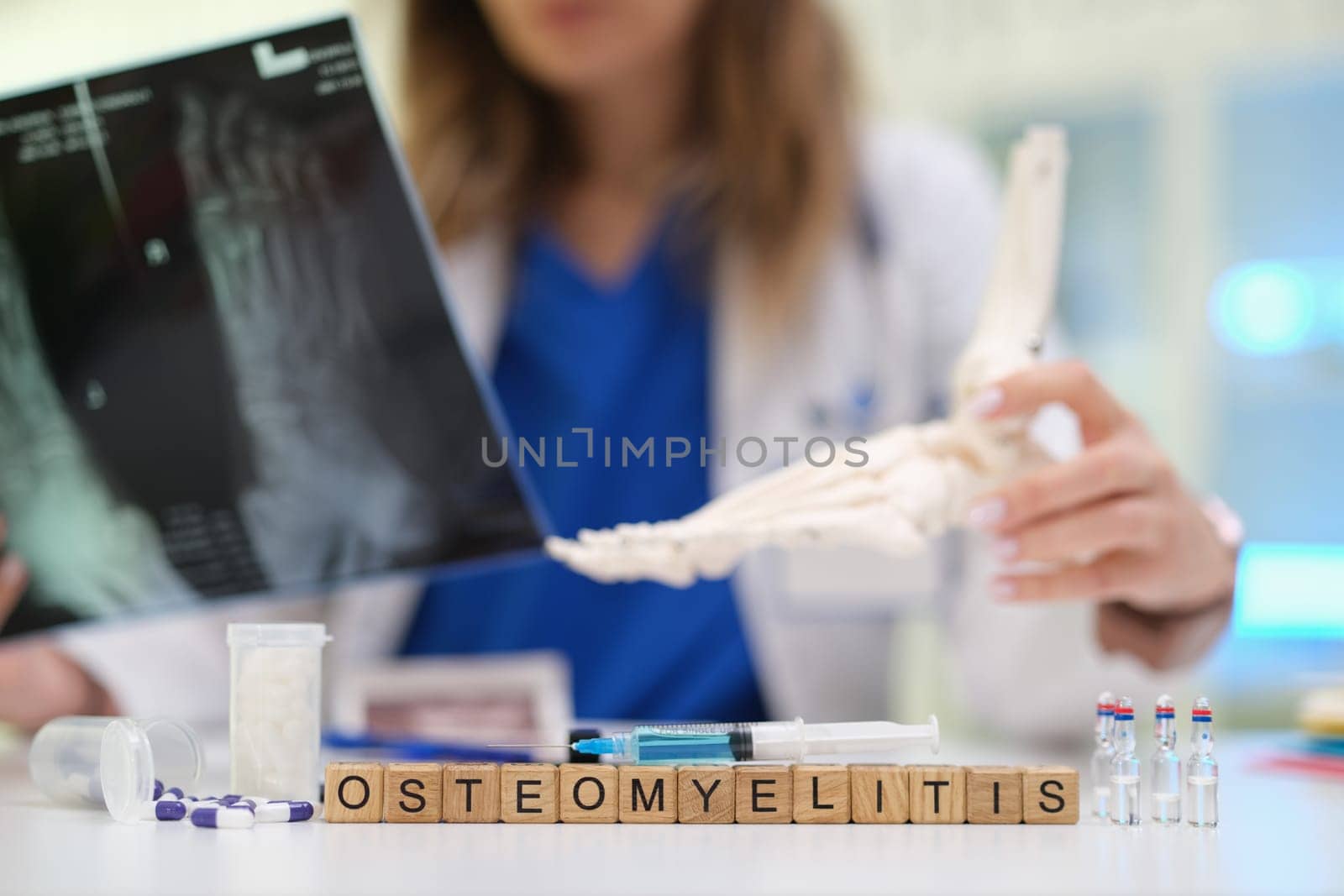 A qualified healthcare professional assesses osteomyelitis using Xray and an anatomical foot model for accuracy