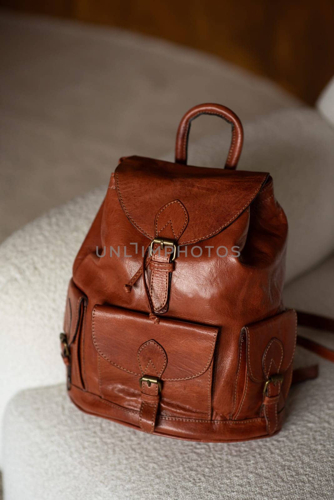 photo of a brown leather backpack with retro look. indoors photo