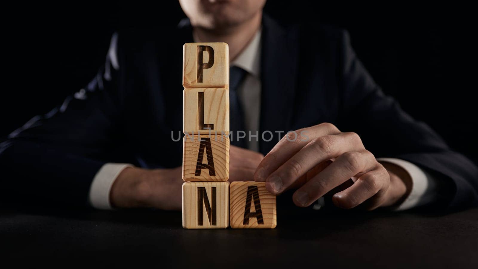 the hand highlights the letter A from the plan