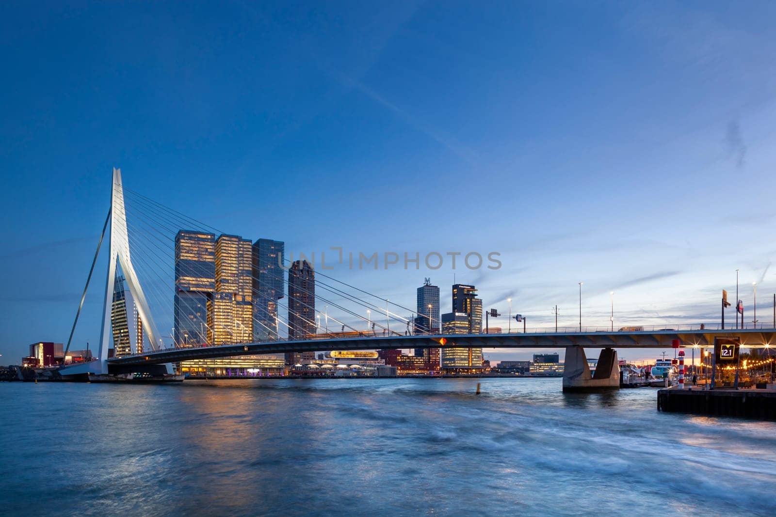 Skyline with the famous Erasmusbrug or Erasmus bridge at twilight in Rotterdam, Netherlands on November 6, 2018