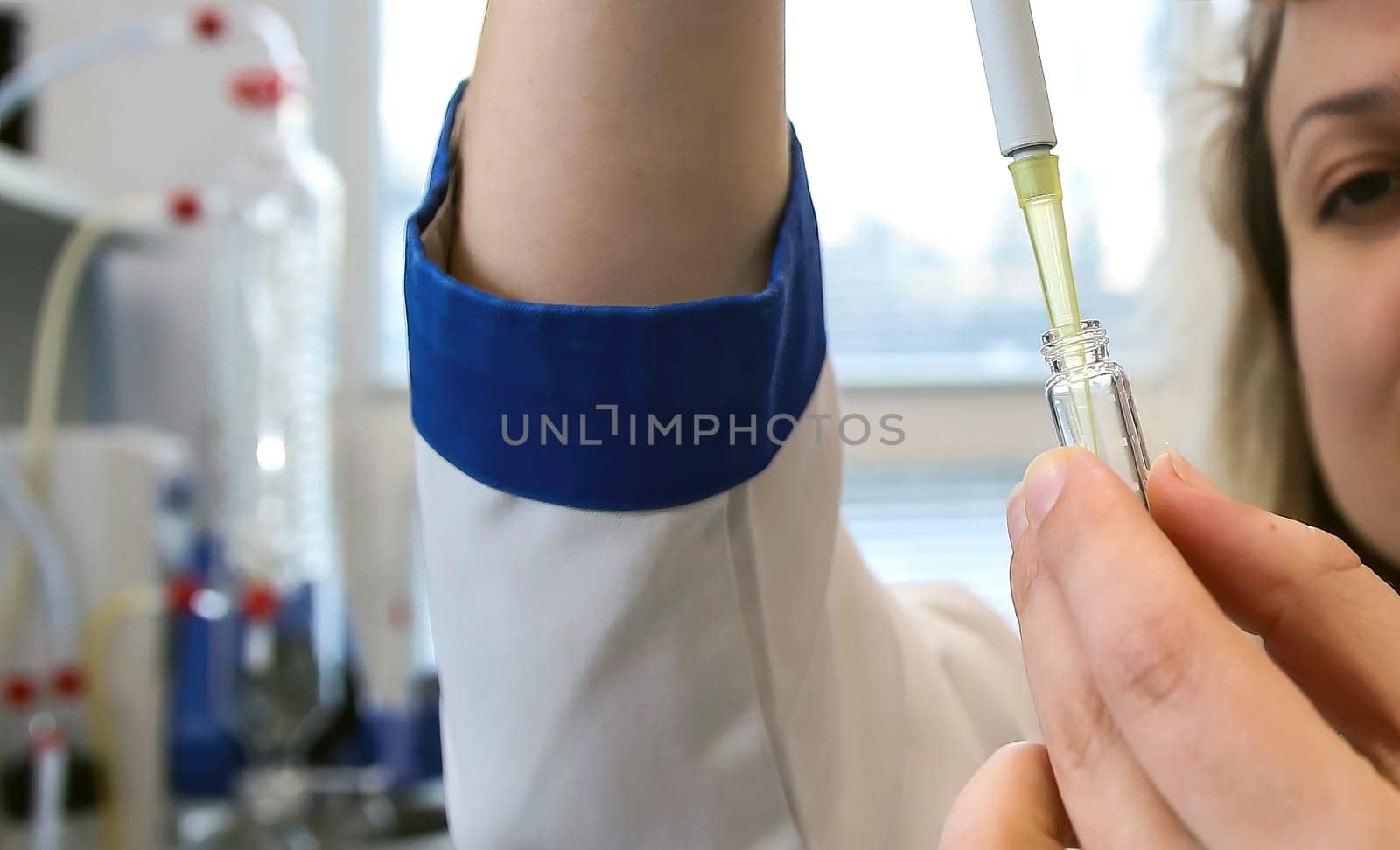 A female laboratory assistant uses a special pipette to work with biomaterial. Analysis of liquids.