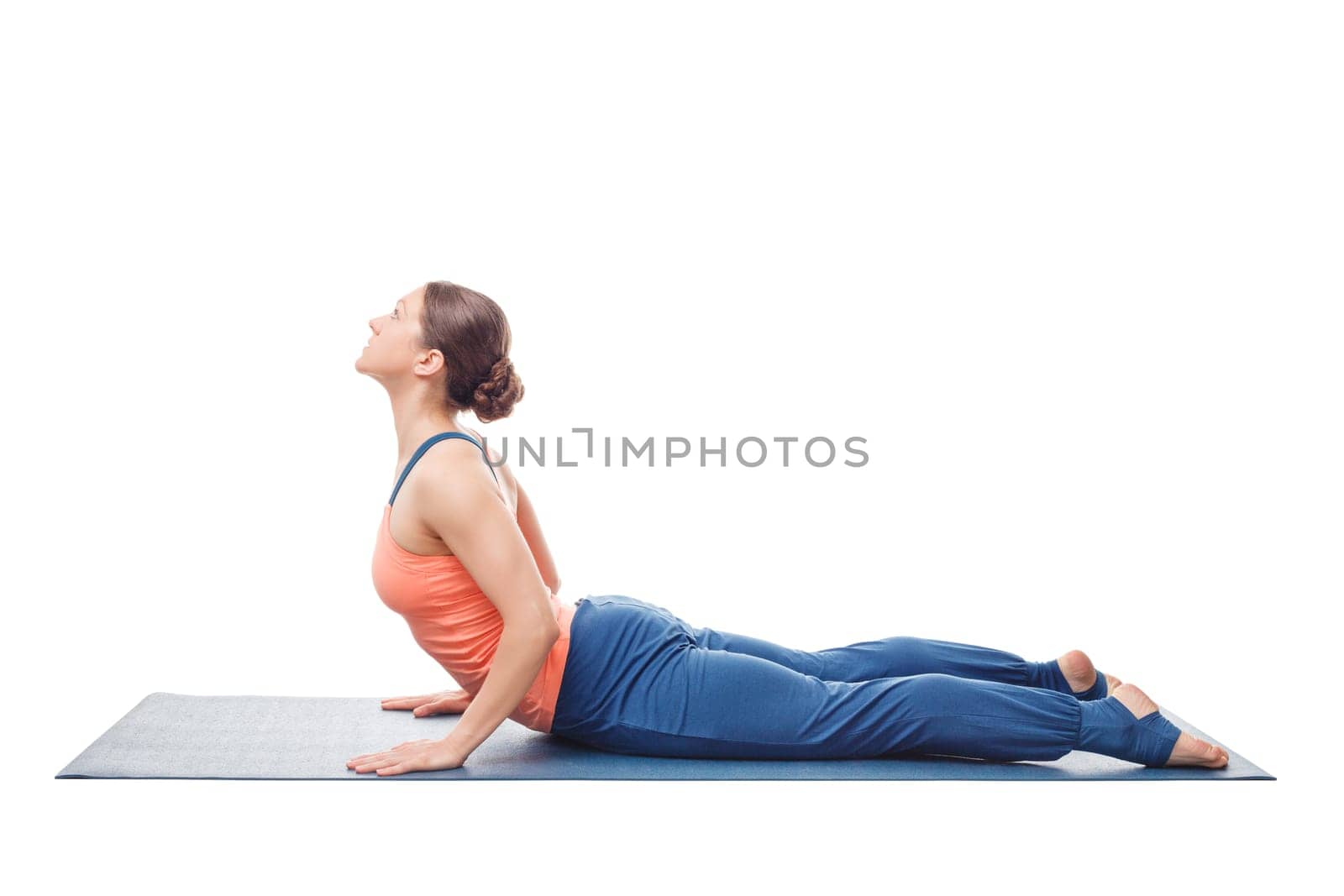 Sporty fit yogini woman practices yoga asana bhujangasana by dimol
