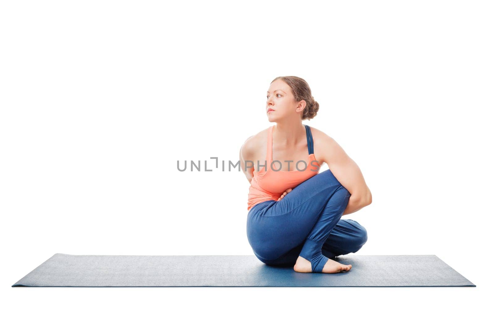 Woman doing Ashtanga Vinyasa Yoga asana Marichyasana D by dimol