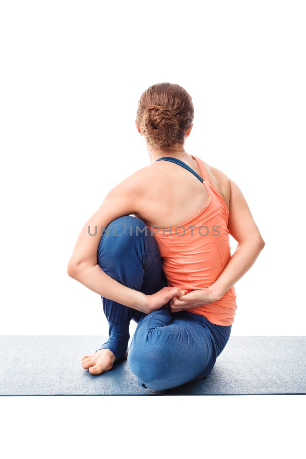 Woman doing Ashtanga Vinyasa Yoga stretching asana Marichyasana D - pose posture dedicated to sage Marichi on white background