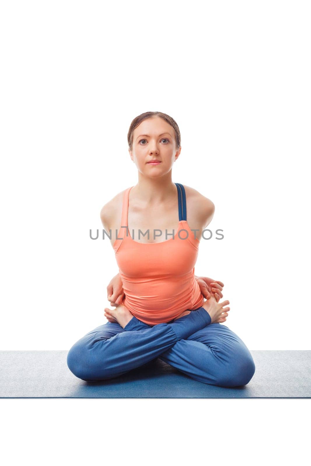 Sporty fit woman doing Ashtanga Vinyasa yoga asana Baddha Padmasana - bound restrained lotus pose isolated on white