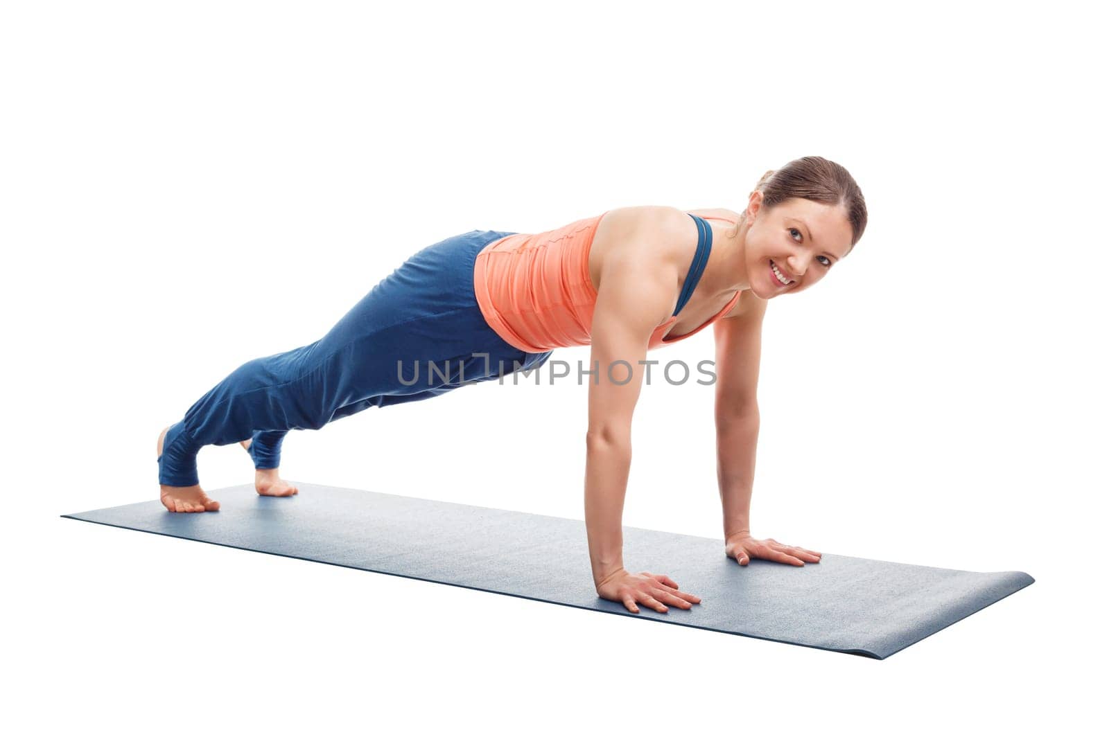 Smiling woman doing Ashtanga Vinyasa yoga asana Utthita chaturanga dandasana (or phalakasana) - extended four-limbed posture plank pose isolated on white background