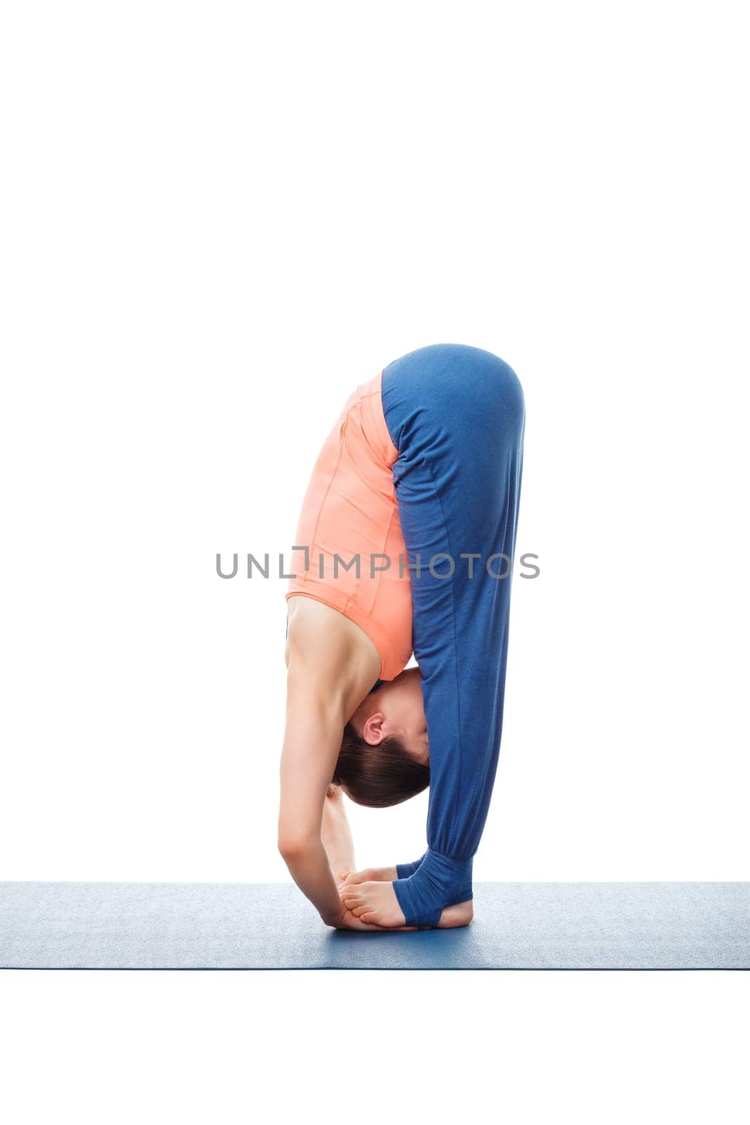 Woman doing Ashtanga Vinyasa Yoga asana Padahastasana - standing forward bend with hand under feet pose posture isolated on white background