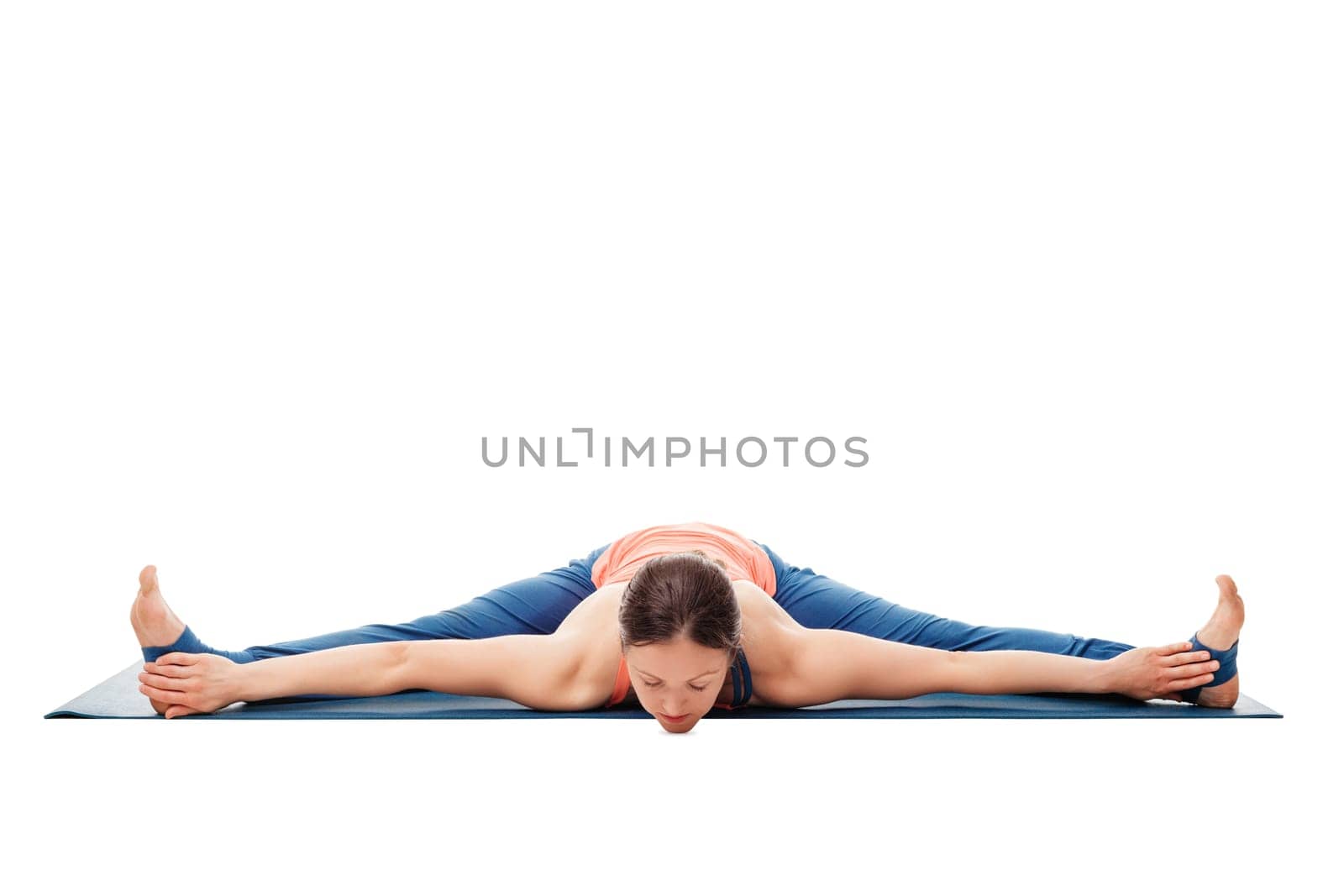 Woman doing Ashtanga Vinyasa Yoga asana Upavistha konasana - wide angle seated forward bend isolated on white background