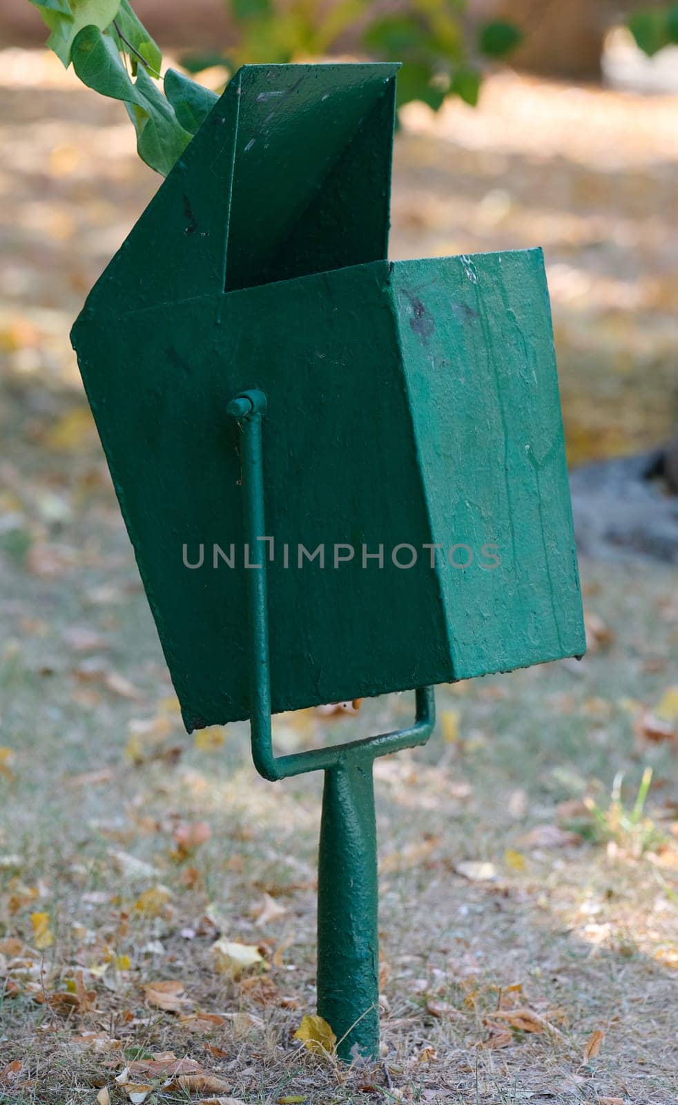 Empty trash can on city street by ndanko