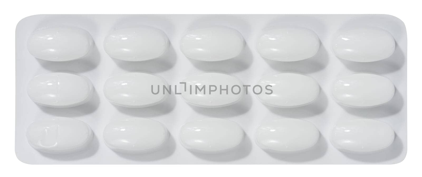 Oval tablets in white plastic packaging, top view by ndanko