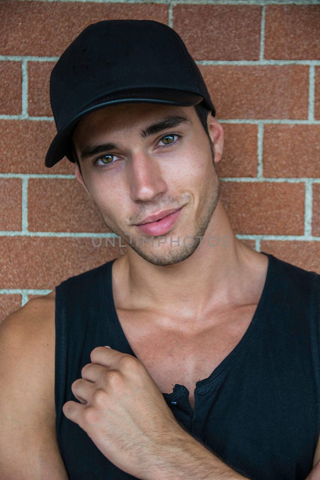Photo of a stylish and handsome young man wearing a black shirt and hat by artofphoto